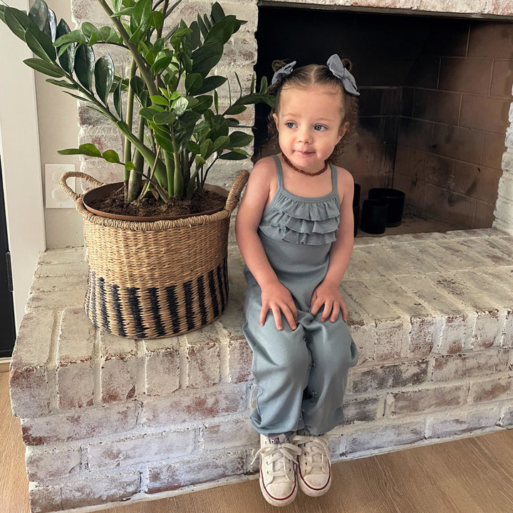 Child wearing Cross-Back Romper in Pool.