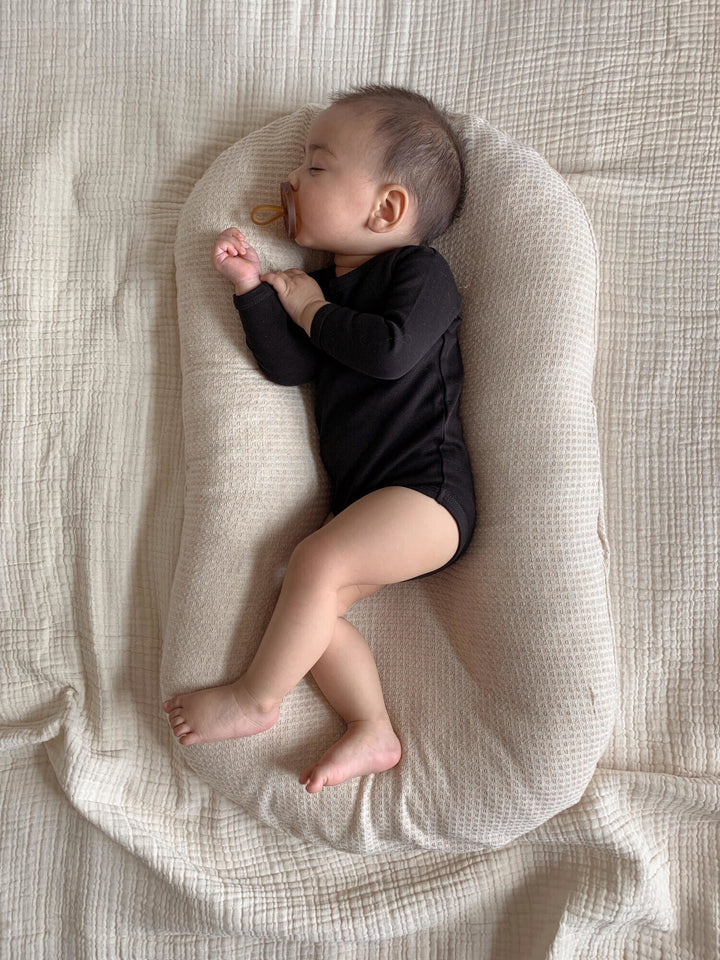 Child wearing Organic Long-Sleeve Bodysuit in Black.