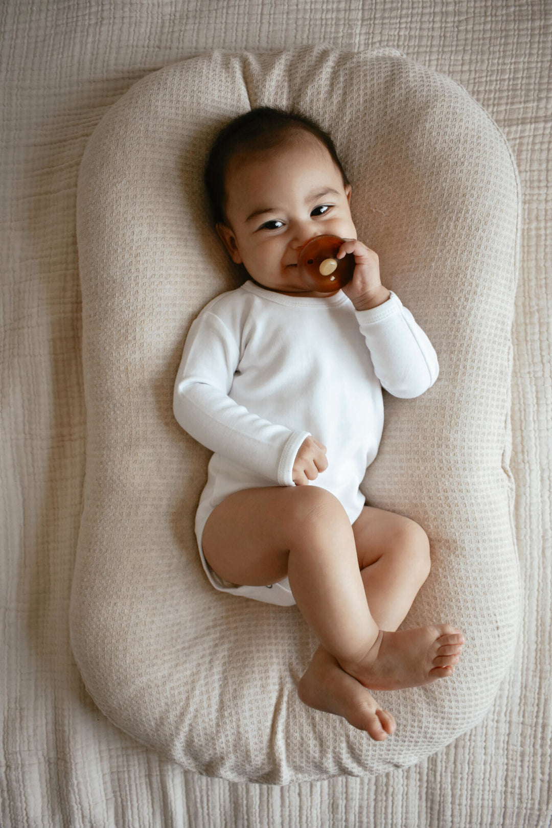 Child wearing Organic Long-Sleeve Bodysuit in White.