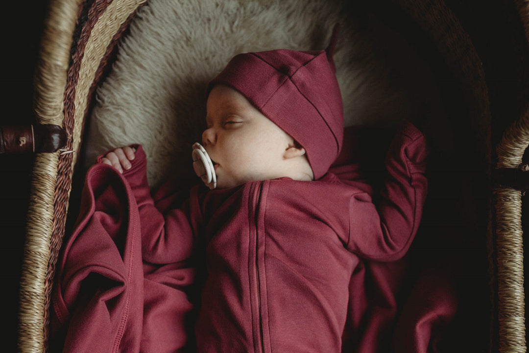 Child wearing Organic Banded Top-Knot Hat in Appleberry.