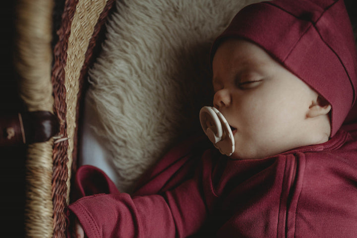 Child wearing Organic Banded Top-Knot Hat in Appleberry.