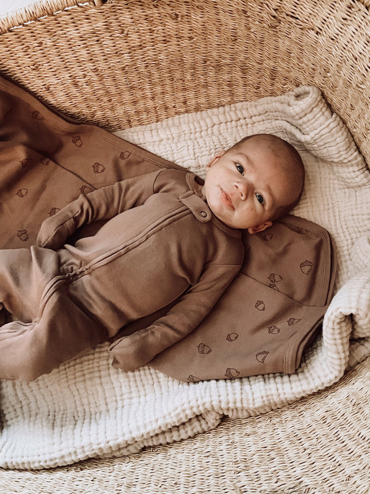 Child wearing Organic Zipper Footie in Latte.