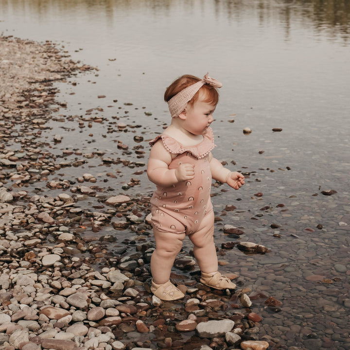 Child wearing Printed Bubble Romper in Mauve Rainbow.