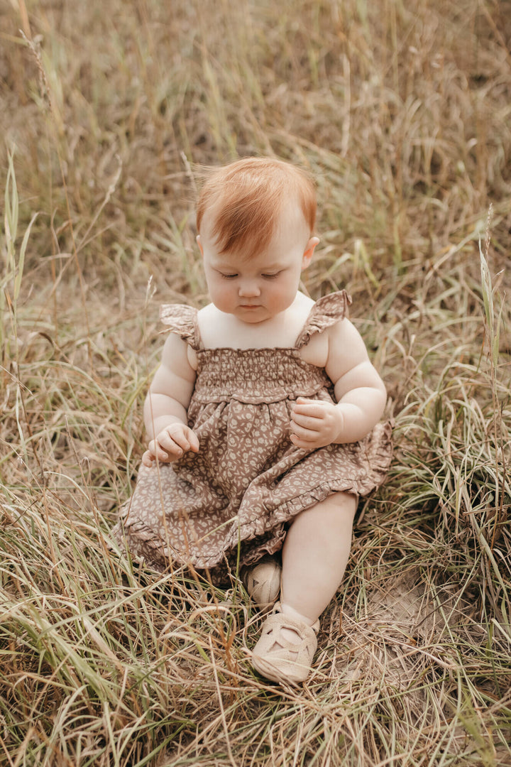 Child wearing Printed Smocked Summer Dress in Latte Floral.