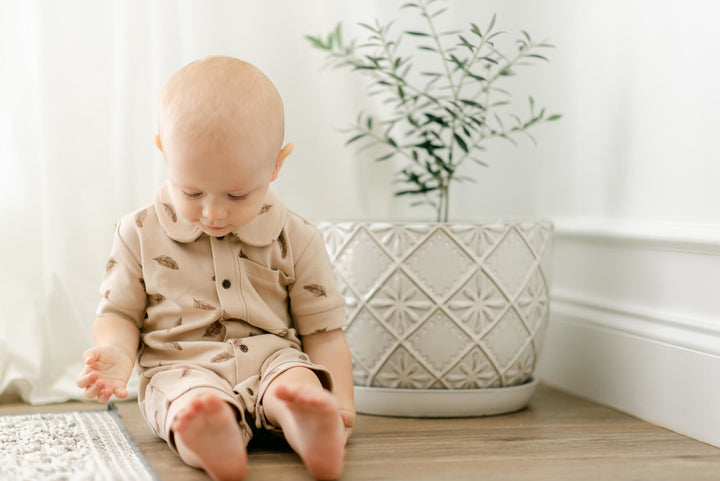 Child wearing Printed S/Sleeve Coverall in Oatmeal Feather.