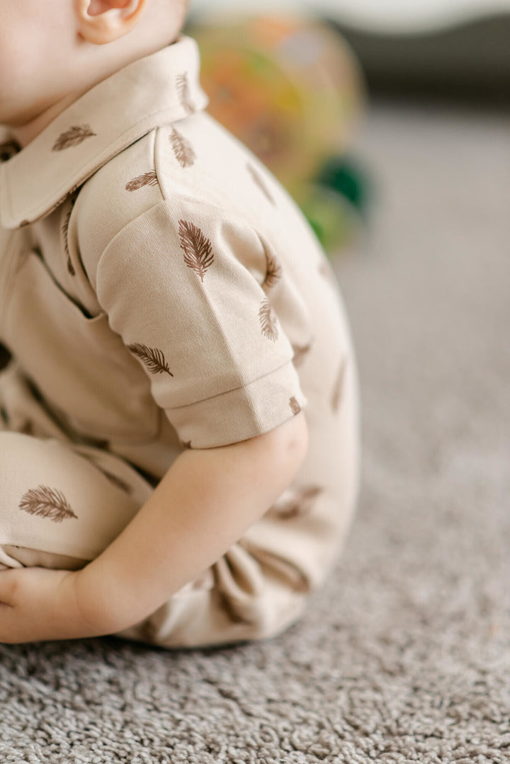 Child wearing Printed S/Sleeve Coverall in Oatmeal Feather.