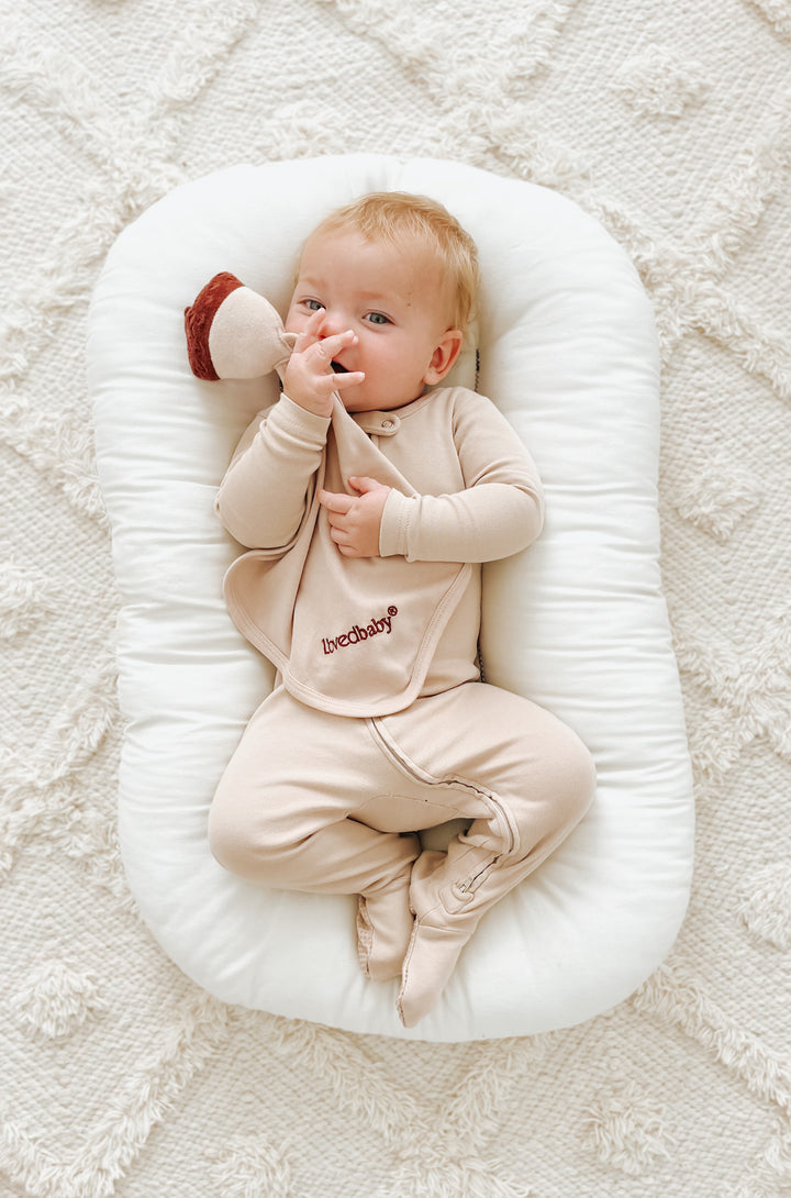 Child wearing Organic Cotton Lovey in Oatmeal.