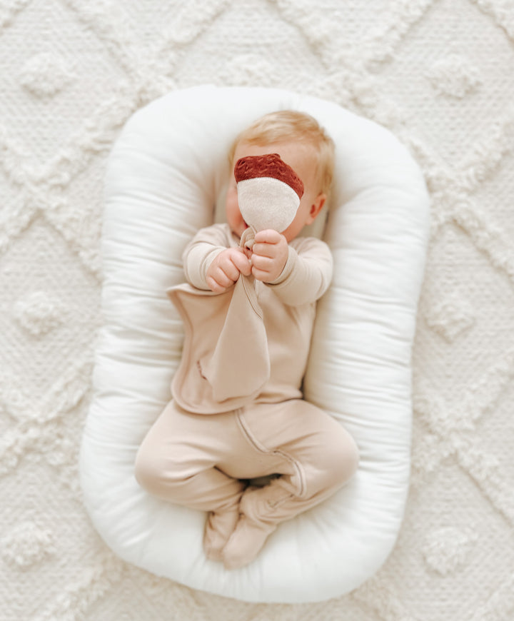 Child wearing Organic Cotton Lovey in Oatmeal.