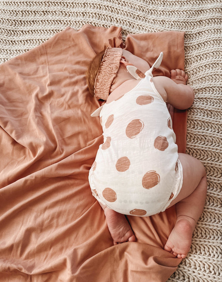 Child wearing Slub Jersey Bodysuit in Adobe Dot.