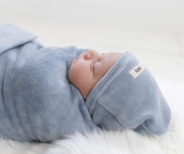 Child Wearing our Organic Velour Cute Cap in Light Gray.