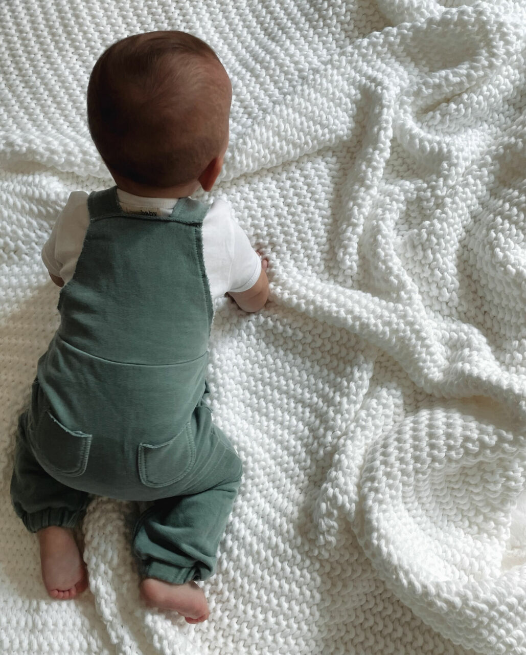 Child wearing French Terry Overall Romper in Jade.