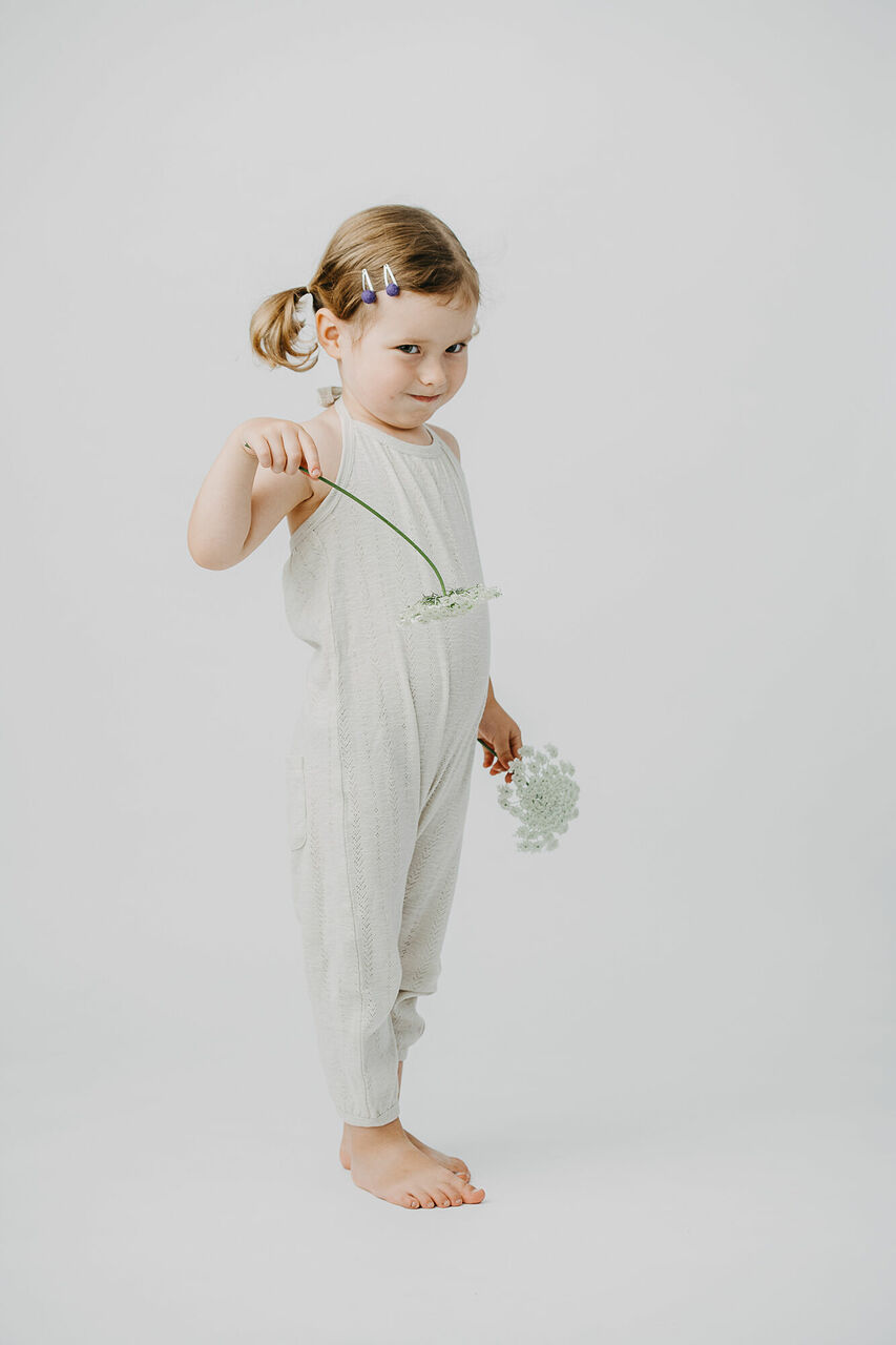 Child wearing Kid's Pointelle Halter Romper in Seashell.