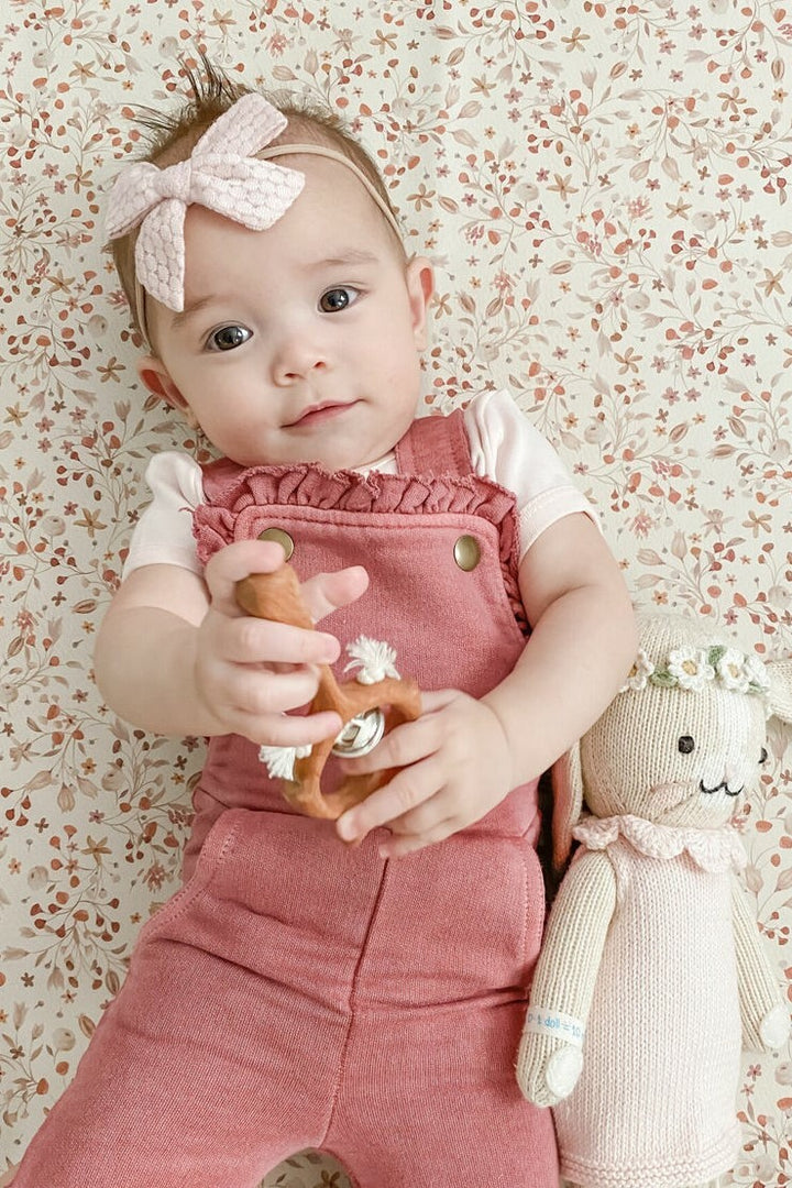 Child wearing French Terry Ruffle Romper in Sienna.