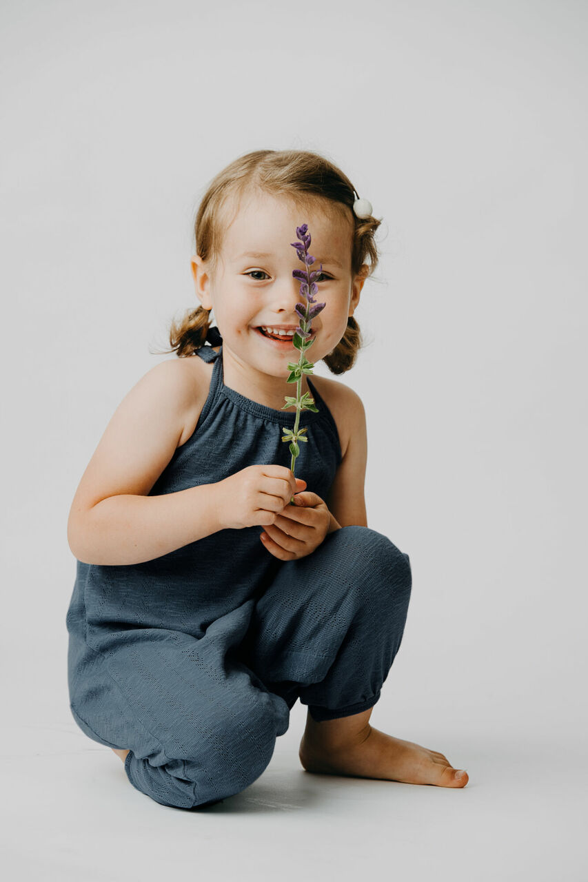 Child wearing Kid's Pointelle Halter Romper in Dolphin.