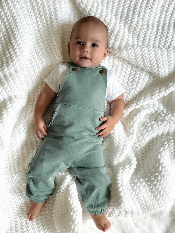 Child wearing French Terry Overall Romper in Jade.