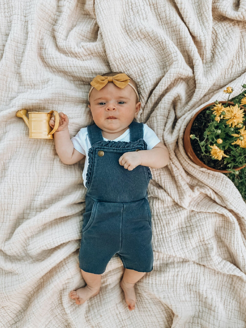 Child wearing French Terry Ruffle Romper in Indigo.