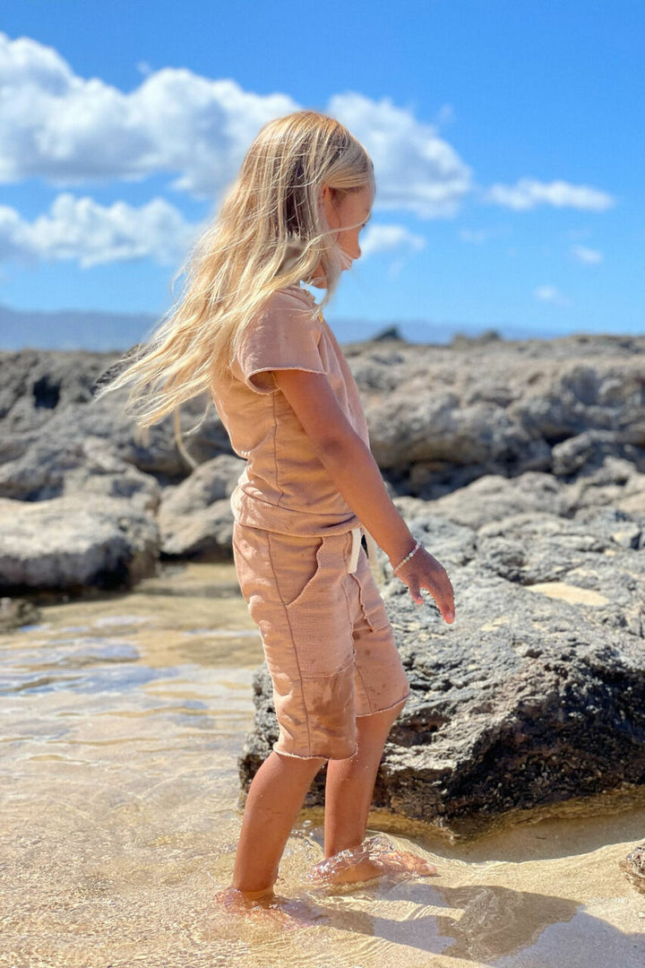 Child wearing Kids' French Terry Shorts & Tee Set in Adobe.