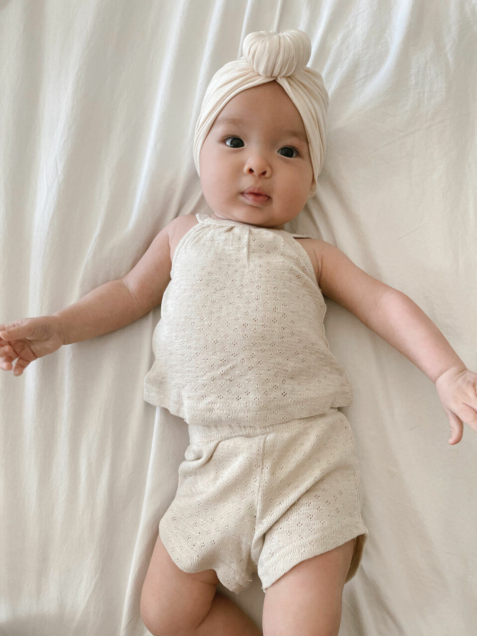 Child wearing Pointelle Tank & Tap Short Set in Seashell.