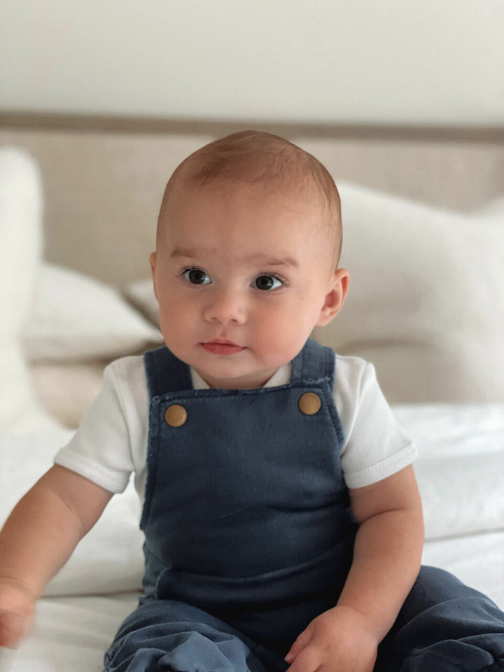 Child wearing French Terry Overall Romper in Indigo.