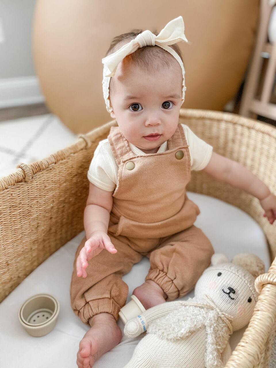 Child wearing French Terry Overall Romper in Adobe.