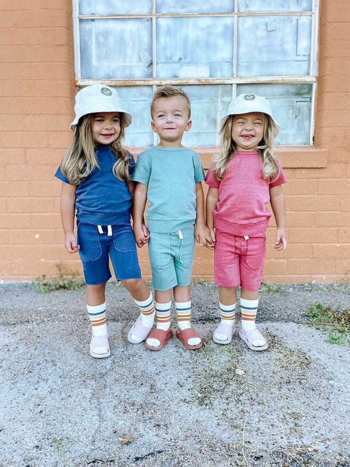 Child wearing Kids' French Terry Shorts & Tee Set in Indigo.