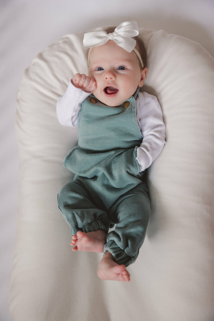 Child wearing French Terry Overall Romper in Jade.