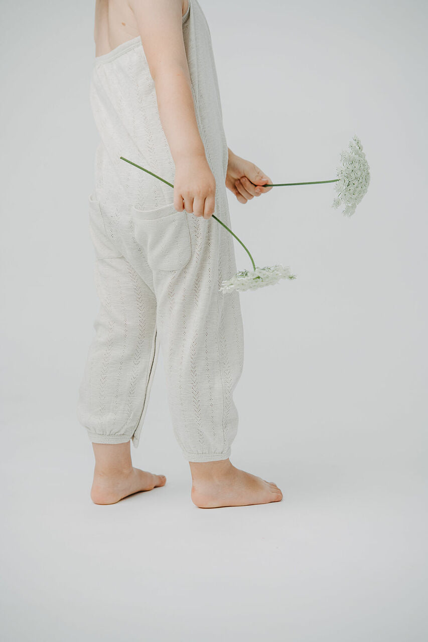 Child wearing Kid's Pointelle Halter Romper in Seashell.