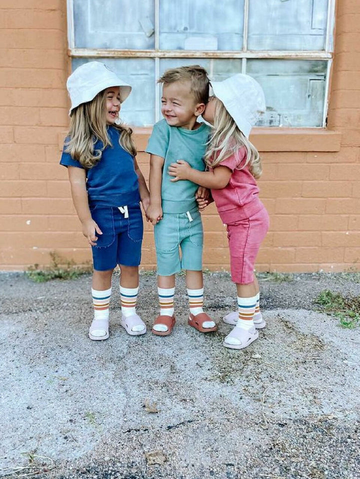 Child wearing Kids' French Terry Shorts & Tee Set in Indigo.