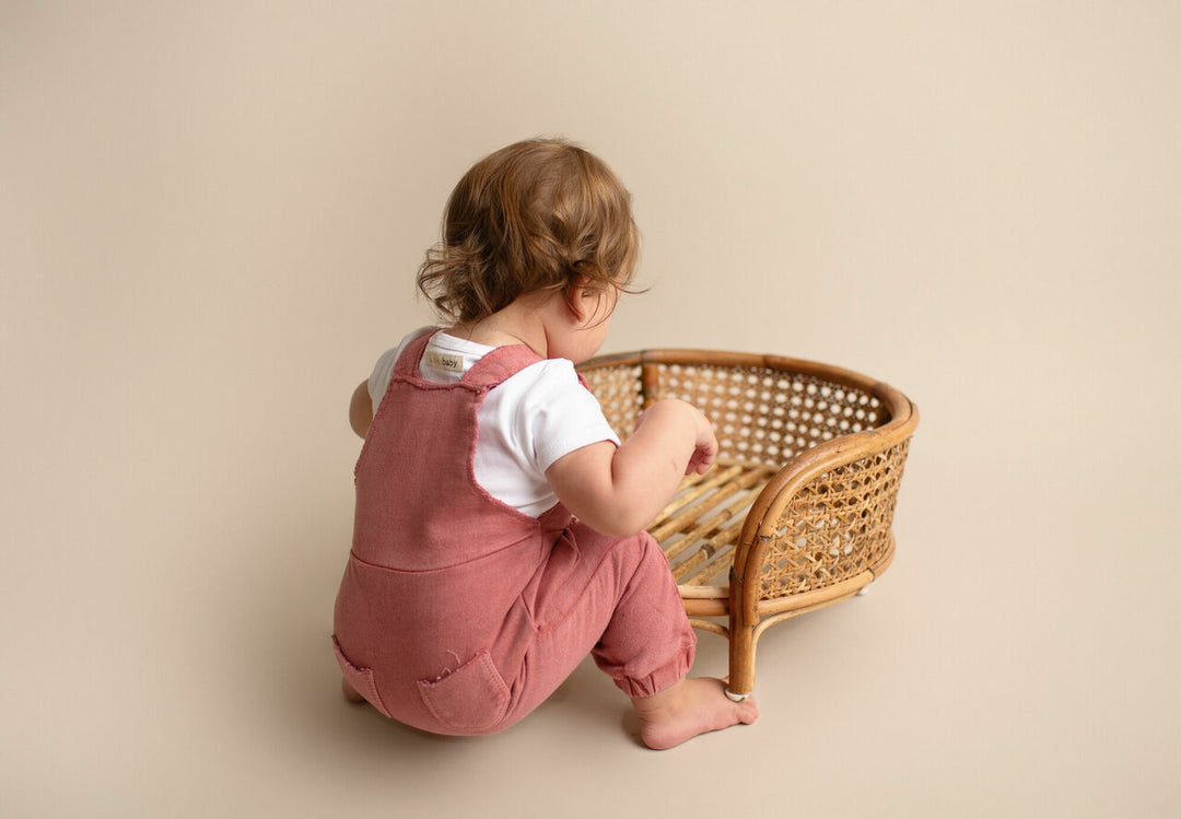 Child wearing French Terry Overall Romper in Sienna.